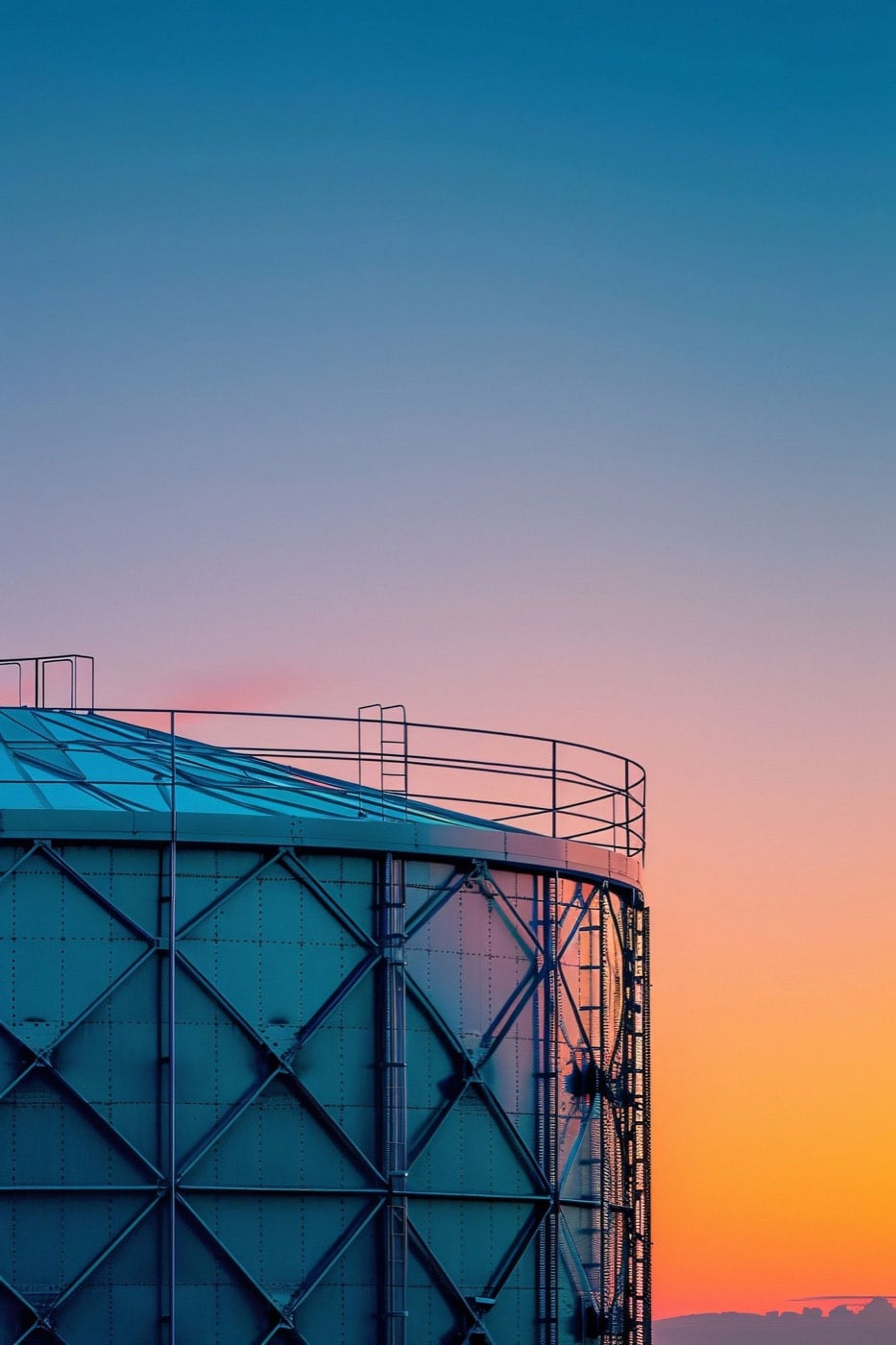 Storage tank at an upstream production facility at dusk